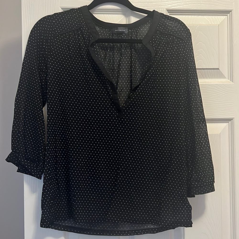 Stretchy black blouse with white spots